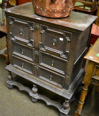 Lot 1300 - A 17th century and later oak geometric chest on stand