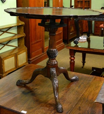 Lot 1301 - A mahogany tilt top tripod table with shaped rim, bird cage and carved cabriole supports