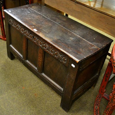 Lot 1304 - An early 18th century oak coffer with triple panelled front and candle box