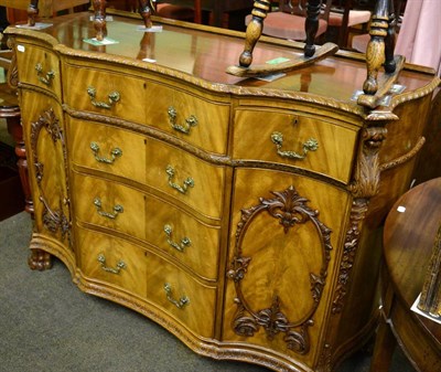 Lot 1309 - A carved mahogany Chippendale style serpentine shaped sideboard, possibly by Hille