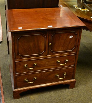 Lot 1316 - A George III style mahogany commode with a cupboard over two drawers