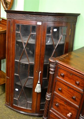 Lot 1325 - A Georgian glazed bow fronted corner cupboard