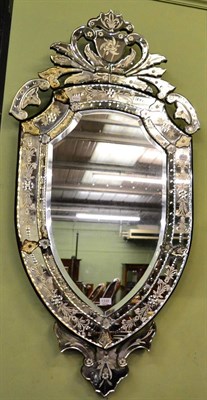 Lot 1335 - A Venetian engraved shield shaped wall mirror