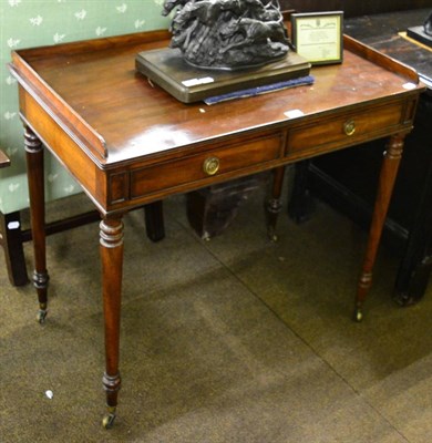 Lot 1339 - A George III mahogany two drawer table with gallery