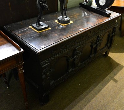 Lot 1340 - A 17th century oak coffer with three arched panels between caryathid figures, formerly forming part