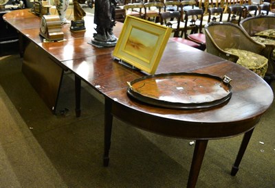 Lot 1341 - A George III large mahogany extending dining table on square tapering supports with spade feet,...