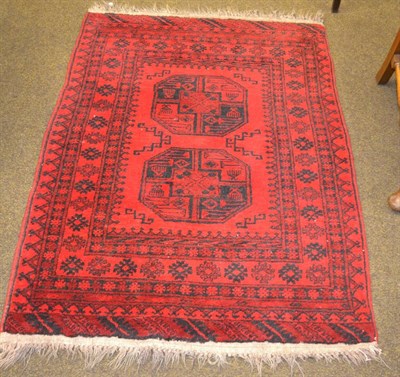 Lot 1353 - A Turkeman rug, North Afghanistan, the crimson field with two elephant foot guls enclosed by...