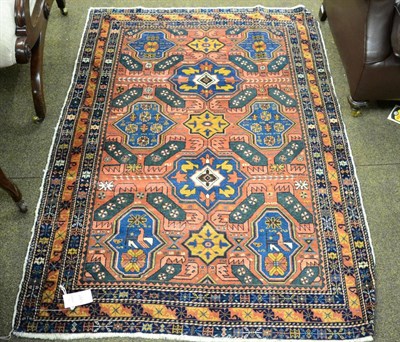 Lot 1357 - Shirvan rug, East Caucasus, the terracotta field with columns of indigo medallions enclosed by...