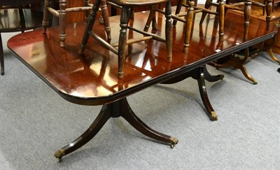 Lot 1375 - A reproduction twin pedestal extending dining table