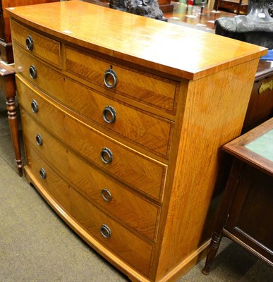 Lot 1381 - A George V satinwood and ebony strung bowfront chest of drawers, labelled P E Gane Ltd, Queen...