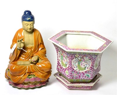 Lot 5 - A Chinese famille rose hexagonal planter and stand; with a seated Buddha (2)