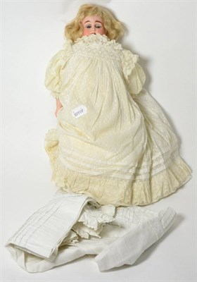 Lot 7 - Bisque shoulder head doll on cream kid leather body, blond hair, fully dressed with extra clothing