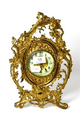 Lot 15 - A gilt metal strut clock, the dial with Arabic numerals