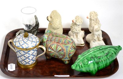 Lot 17 - A Serves porcelain cup and cover, three Staffordshire poodles, two pottery piggy banks, etc