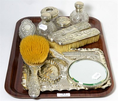 Lot 41 - A silver dressing table set including tray, decorated with putti, together with other dressing...