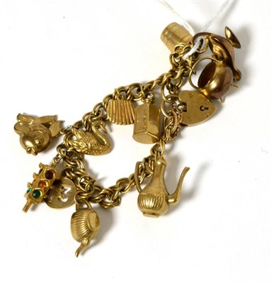 Lot 58 - A charm bracelet, stamped '9CT' with 9 caret gold attached charms