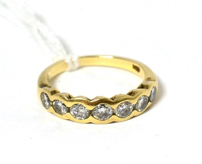 Lot 88 - A diamond half hoop ring, seven round brilliant cut diamonds in rubbed over settings, total...