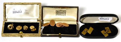 Lot 93 - A pair of 9 carat gold engine turned double oval cufflinks, a matched set of dress studs and a pair