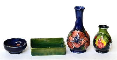 Lot 108 - Walter Moorcroft: Orchid pattern small bowl, Leaf and Berry pattern vase, Anemone pattern vase,...