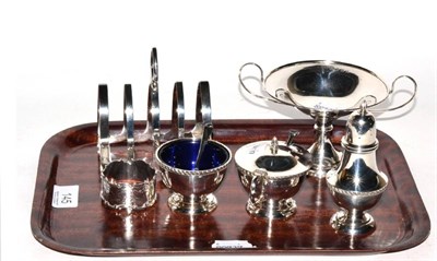 Lot 145 - Silver comprising three piece condiment set, toast rack, napkin ring and pedestal dish