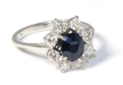 Lot 156 - A sapphire and diamond cluster ring, total estimated diamond weight 0.65 carat approximately,...