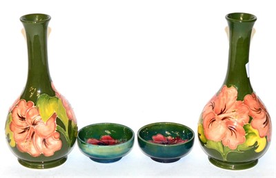 Lot 224 - A pair of Walter Moorcroft Coral Hibiscus vases, on green grounds, and two Walter Moorcroft...