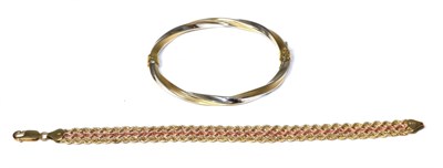 Lot 314 - A 9 carat two colour gold bangle and a 9 carat gold bracelet (2)