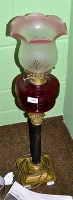 Lot 346 - A Victorian brass lamp with ruby glass reservoir