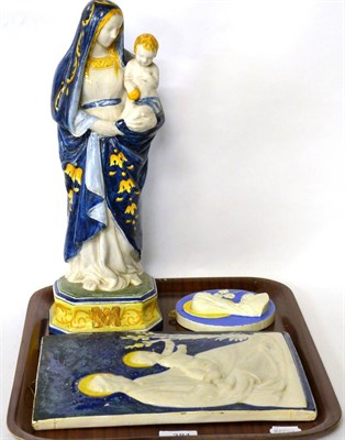 Lot 381 - A 19th century tin glazed earthenware figure of Madonna and Child, together with two further pieces