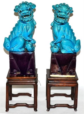 Lot 407 - A pair of Chinese turquoise glazed temple dogs and a pair of stands with marble tops