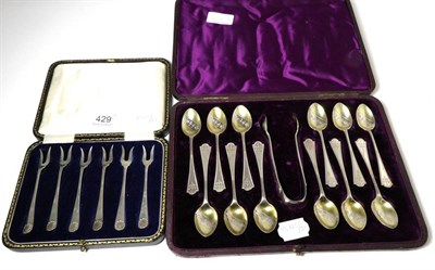 Lot 429 - A set of twelve Victorian parcel-gilt silver teaspoons and tongs; Richard Martin & Ebenezer...