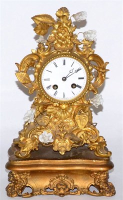 Lot 441 - French gilt bronze foliate design mantel clock, with porcelain flowers on gilt wood stand