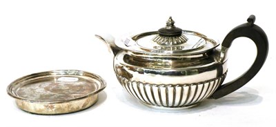 Lot 480 - George III silver teapot, W B R S, London 1808, with matching circular stand, crest engraved to one