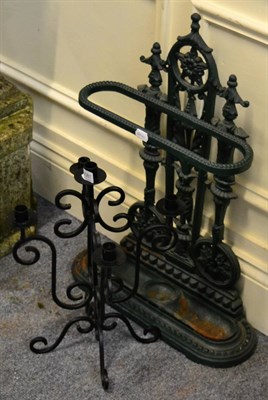 Lot 1081 - Reproduction painted cast iron umbrella stand, together with a wrought iron candelabra