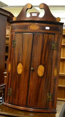 Lot 1096 - An inlaid mahogany bow fronted hanging corner cupboard