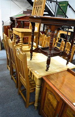 Lot 1102 - A pine kitchen table and eight pine chairs, with carved top rails (9)