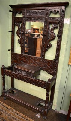 Lot 1244 - Carved oak mirrored hall stand