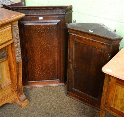 Lot 1248 - Two George III panelled oak hanging corner cupboards