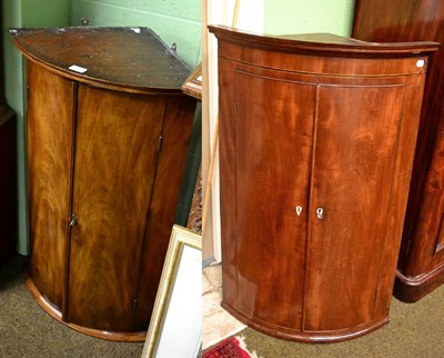 Lot 1251 - Two George III mahogany bow fronted hanging corner cupboards (2)