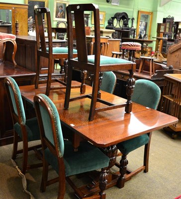 Lot 1254 - A 1920's oak extending dining table, a set of four 1920's oak dining chairs and a pair of...