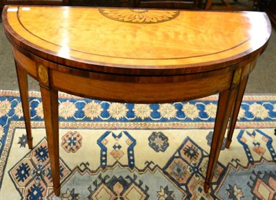 Lot 1280 - George III satinwood and inlaid fold over games table