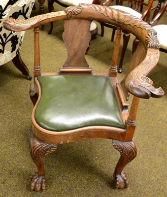 Lot 1296 - A 19th century carved mahogany corner chair with acanthus leaf crest rail continuing to dolphin...