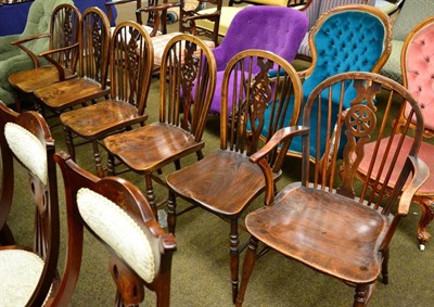 Lot 1300 - Set of six elm wheel back chairs, including two carvers