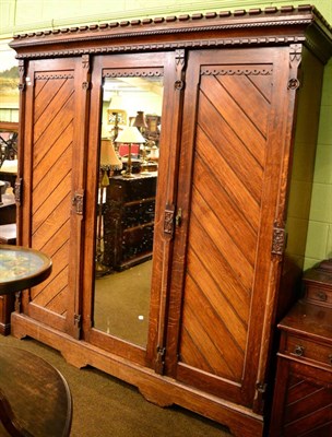 Lot 1338 - Large mirrored oak triple wardrobe