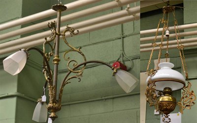 Lot 1348 - A late 19th/early 20th century brass chandelier with frosted shades and a gilt metal light...