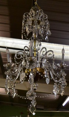 Lot 1351 - A large glass six branch chandelier with faceted drops