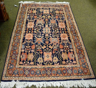 Lot 1353 - An Indian rug, the field of large flowering plants enclosed by terracotta borders, enclosed by...