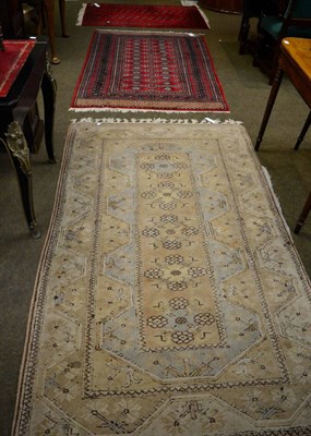 Lot 1355 - A Lahore Bukhara rug, Punjab, the blood red field with a column of quartered guls enclosed by...