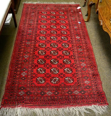 Lot 1356 - A Turkmen rug, North Afghanistan, the brick red field of octagonal guls enclosed by multiple...