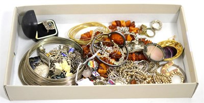 Lot 11 - A collection of costume and silver jewellery, including an amber bangle, charm bracelets,...